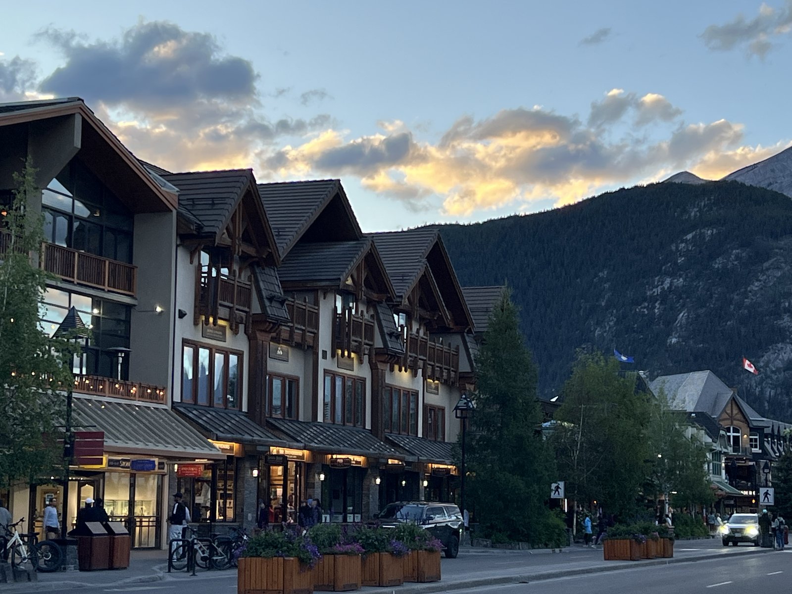 Banff Avenue at dusk, golden clouds over the mountains