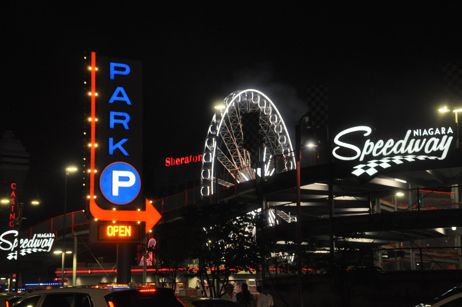 Niagara Speedway neon and a lit ferris wheel at night